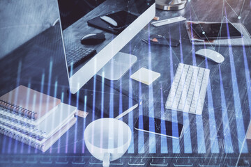 Double exposure of graph and financial info and work space with computer background. Concept of international online trading.