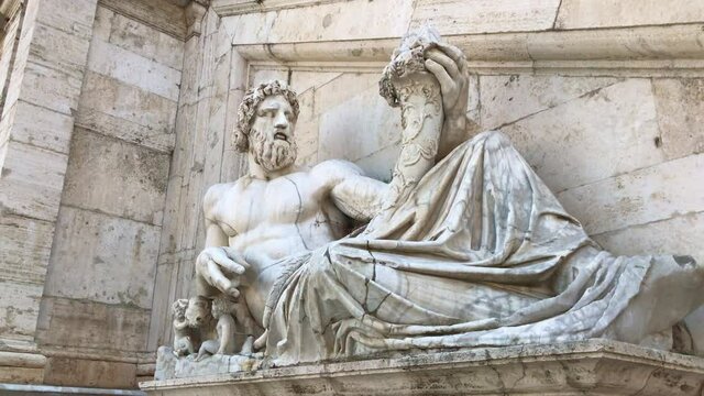 Marble statue of an ancient philosopher and thinker. It's on the building.