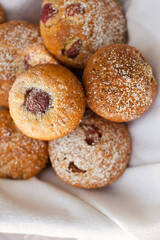Outdoor studio photo of fresh muffins, bright background. Shallow depth of field, selective focus.