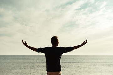 Happy man Enjoying Dancing in the Beautiful Sunset on the Beach