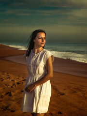 Happy  Woman Enjoying Dancing in the Beautiful Sunset on the Beach