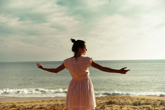 Happy Carefree Woman Enjoying Dancing in the Beautiful Sunset on the Beach