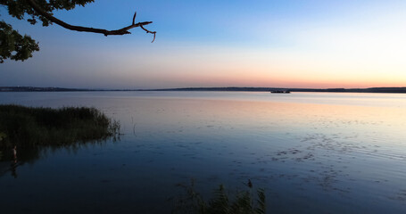 Obraz na płótnie Canvas River bank at sunset