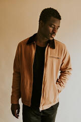 Brown short jacket mockup on African Amercan male model in studio