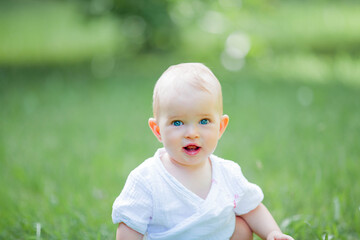 little cute girl eating strawberries from a basket outdoors