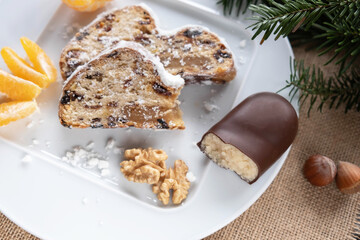 two pieces of Christmas cake with marzipan, nuts and raisins, tangerine, walnut and marzipan, close-up