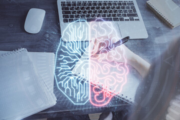 Multi exposure of writing hand on background with brain hologram. Concept of learning.
