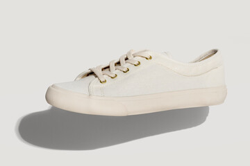 Unisex white sneakers on a white background