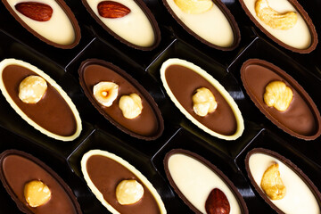 Chocolates with nuts in a box. View from above