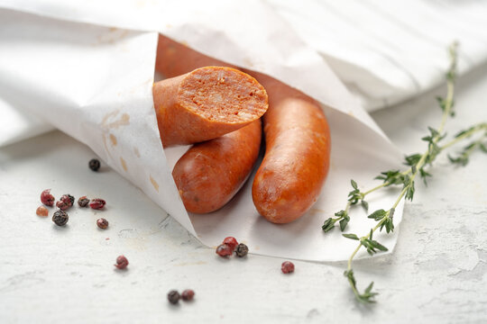 Traditional Spanish Chorizo sausages wrapped in paper with pepper and herbs