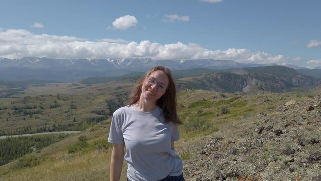 Happy woman in Altai mountains. Vacation, travel and adventure concept