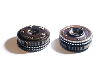 Two exhaust camshaft adjusters on a white background. The mechanism for changing the timing of the timing.