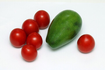Tomatoes and avocado on white