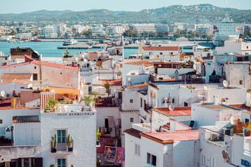 Beautiful cityscape of Ibiza with colorful houses and a harbor on a sunny day