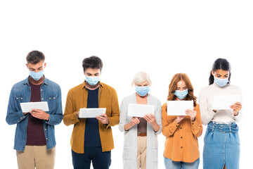Obraz premium Multiethnic people in medical masks using digital tablets isolated on white