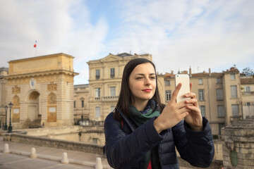 traveling woman taking a selfie in France