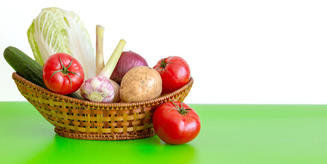 The wicker basket is on the green table with Vegetarian Vegetables