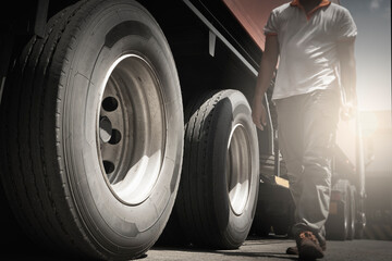 Close-up, a truck wheels. Truck inspection maintenance and repairing. A truck driver walking and...