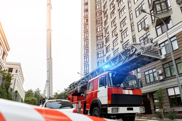 Many fire engine trucks with ladder and safety equipment at accident in highrise tower residential...