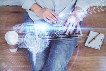 Businessman with computer background with brain theme hologram. Concept of brainstorm. Multi exposure.