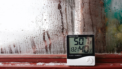 Thermometer and hygrometer of electronic to control temperature and humidity. Humidity indicator is indicated on the hygrometer of the device - obrazy, fototapety, plakaty