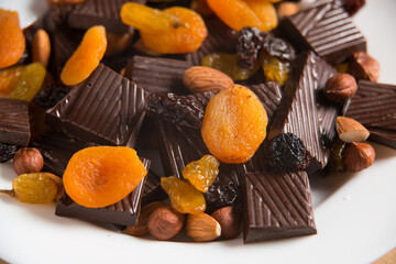 Close-up of a homemade chocolate bar with raisins, dried apricot and nuts