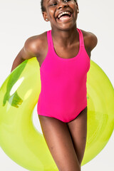 Fototapeta na wymiar Black woman in a pink swimsuit with swim tube