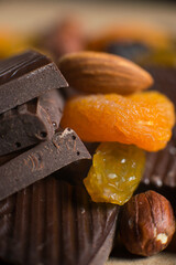 Close-up of a homemade chocolate bar with raisins, dried apricot and nuts