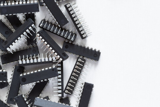 Lots of microcircuits or chips on a white background with copy space. Electronic components