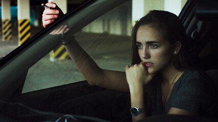 Fototapeta na wymiar woman smoking cigarette in car