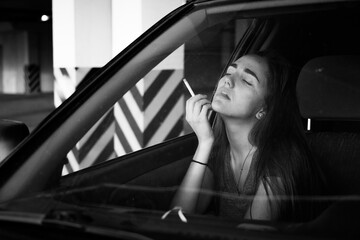 Fototapeta na wymiar woman smoking cigarette in the car