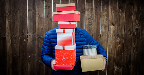 man holding pile of Christmas gift boxes