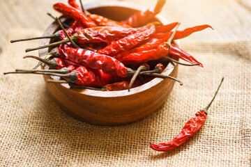 Dried chili on bowl - Red dried chilli pepper cayenne on sack background