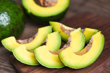 Avocado fruit and slice avocado on wooden background, Fruits healthy food concept.
