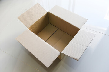 Open cardboard box on floor background, High angle view of an empty cardboard box or Parcel box.