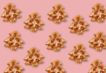 Christmas tree pattern. Pink seamless background. Winter holidays ornament. Beige white gingerbread festive minimalistic symmetrical composition isolated on pink mockup for design.