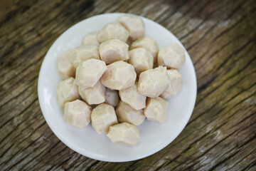 Meat ball on white plate on wooden background, meat ball with pork and ingredient for cooked asian thai food.
