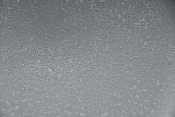 rough grainy textured background with shades of gray as a liquid on a metal surface in black and white backdrop