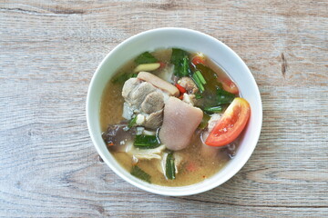 boiled spicy pork leg in tom yum soup on bowl
