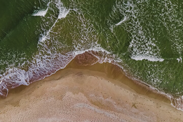 Aerial top view of the beach with sand and small waves