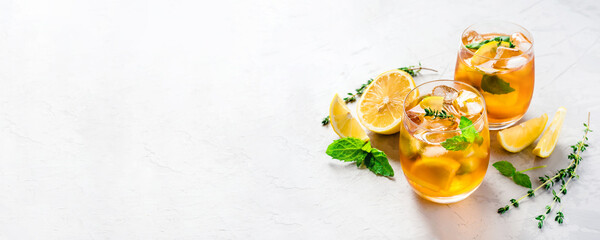 Iced tea with ice, mint and lemon. Refreshment cold summer drink.
