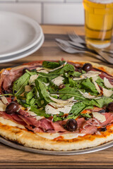 pizza with arugula and raw ham ready to eat