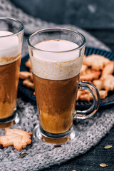 Pumpkin sweet spicy latte with autumn cookies and cinnamon. Grey knitted plaid