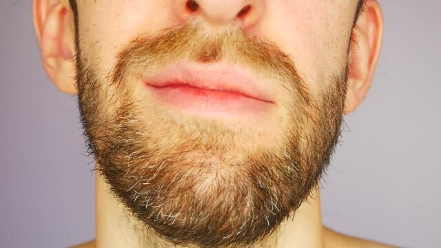 Close-up of a lower part of the face of a man shaking his head as if he speaks NO THIS WILL NOT WORK