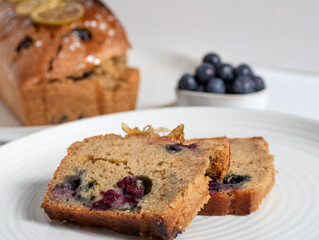 Homemade Lemon and blackberries pound cake sliced. white background. 