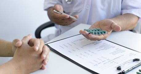 Doctor is advising patients in a hospital diagnostic room.