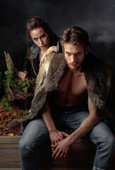 A serious man with a beard and his girlfriend.