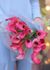 Many blooming pink callas flowers. A bouquet of pink callas lies. Beautiful bouquet of tender flowers.