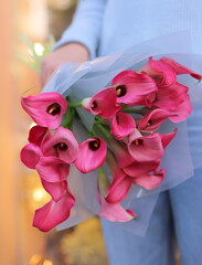 Many blooming pink callas flowers. A bouquet of pink callas lies. Beautiful bouquet of tender flowers.