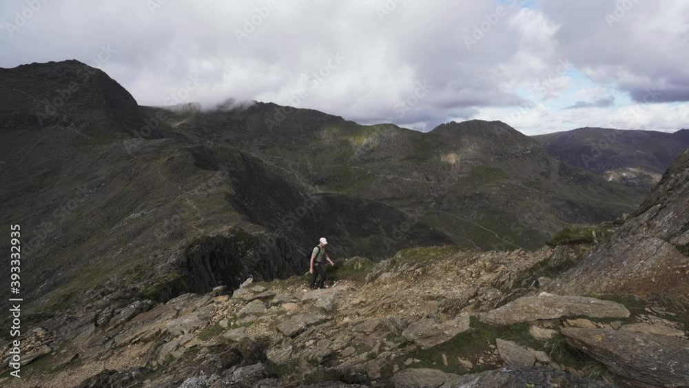 Poster Backpacking hiker climbing a beautiful mountain slope in Snowdonia 